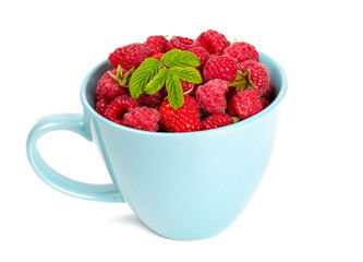 fresh raspberrie in a blue cup
