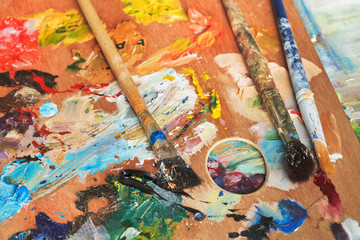 paintbrushes on wooden artistic pallette