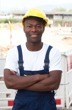 Friendly african construction worker with crossed arms