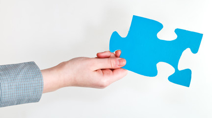 blue puzzle piece in female hand