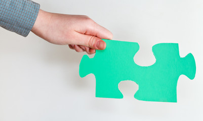green puzzle piece in female hand
