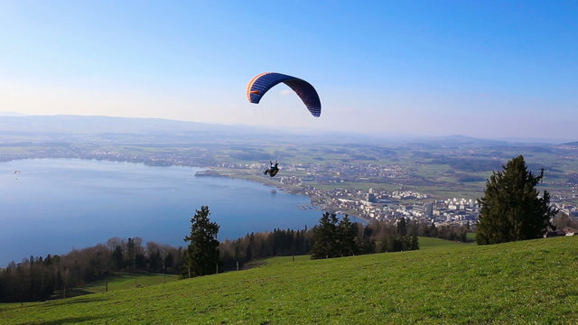 Paraglider over the Zug city, Zugersee and Swiss Alps
