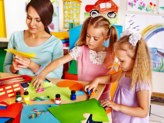 Children with teacher at classroom.