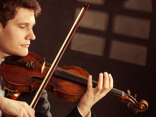 Man violinist playing violin. Classical music art