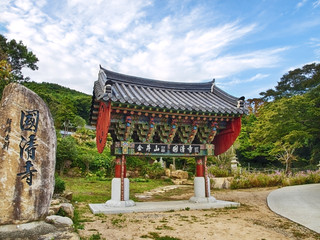 traditional korean gate with big stone in garden