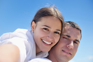 happy young couple have fun on beach