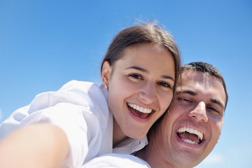 Fototapeta premium happy young couple have fun on beach