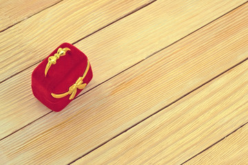 Image of a red gift box on the background of  wooden laths