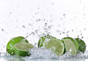 Fototapeta na wymiar Limes with water splash