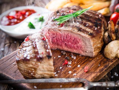 Beef steak on wooden table