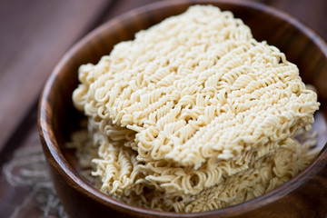 Close-up of dry chinese noodles in a wooden bowl