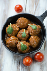 Frying pan with meatballs, vertical shot, above view