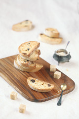 Cardamom Raisin Biscotti on a wooden cutting board.