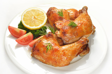 Grilled chicken thigh with vegetables on white plate.