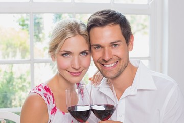 Close-up of a happy loving couple with wine glasses