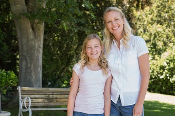 Fototapeta premium Mother and daughter standing together in park