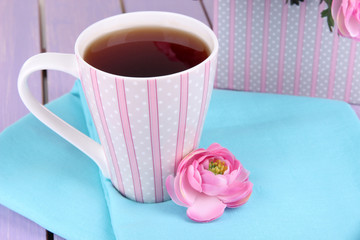 Fragrant tea with flowers on wooden table close-up