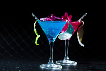 Blue swimming pool Cocktail with caviar and flower petals