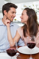 Couple with wine glasses at dining table