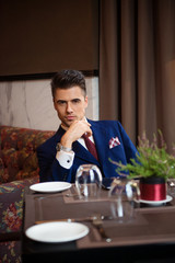 Successful businessman sitting at the table of the restaurant