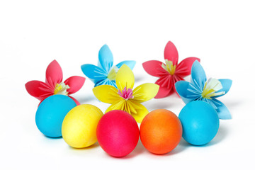 Many Easter eggs and colored paper flowers