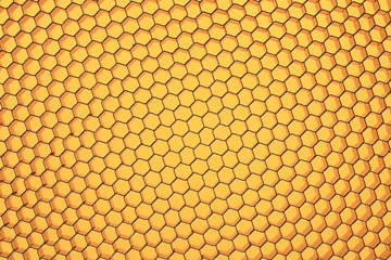Hexagonal mesh on a yellow background.