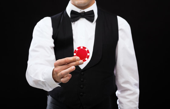 Dealer Holding Red Poker Chip