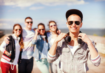 teenage boy with sunglasses and friends outside