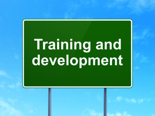 Education concept: Training and Development on road sign