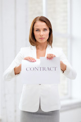 concentrated businesswoman tearing contract