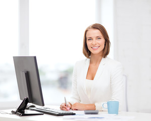 businesswoman with computer, documents and coffee