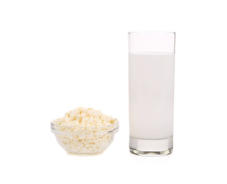 Cottage cheese in bowl and glass of milk.