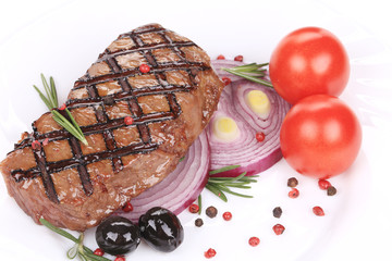 Beef steaks with rosemary and tomatoes.