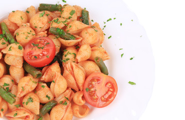 Close up of shells pasta with vegetables.