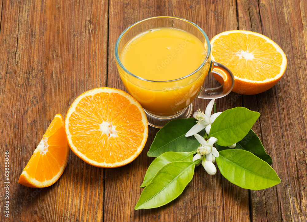 Wall mural Fresh orange juice on the table