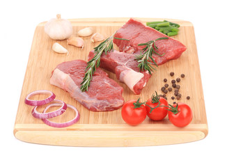 Raw steaks on cutting board.