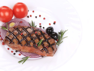 Big juicy grilled steak with greens.