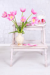 Beautiful pink tulips on grey wall background