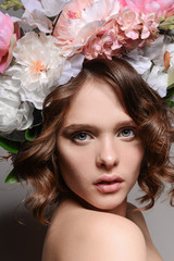Naklejka premium Beauty portrait of a girl with flowers in her hair
