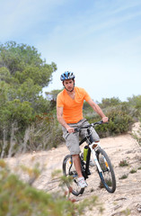 Man riding mountain bike on island trail