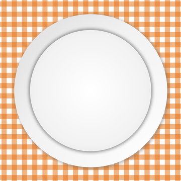 White plate on orange tablecloth