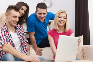 Roommate using laptop in living room