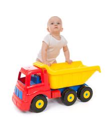 Infant child baby boy toddler with big toy car truck