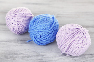 Balls of wool on wooden table background