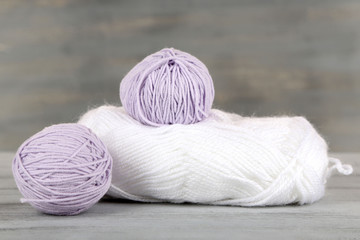 Balls of wool on wooden table background