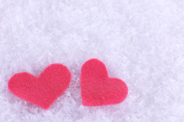 Fototapeta premium Little felt hearts on snowy background