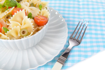 Delicious pasta with tomatoes on plate on table close-up