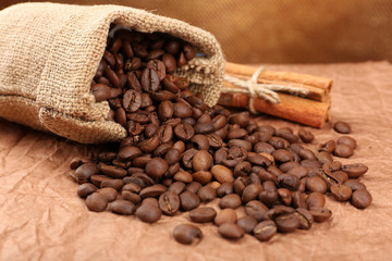 Coffee beans in sack on table close-up