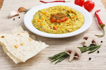 Bowl of tasty fresh hummus, close up