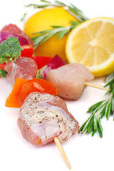 Raw pork kebab with lemon close up